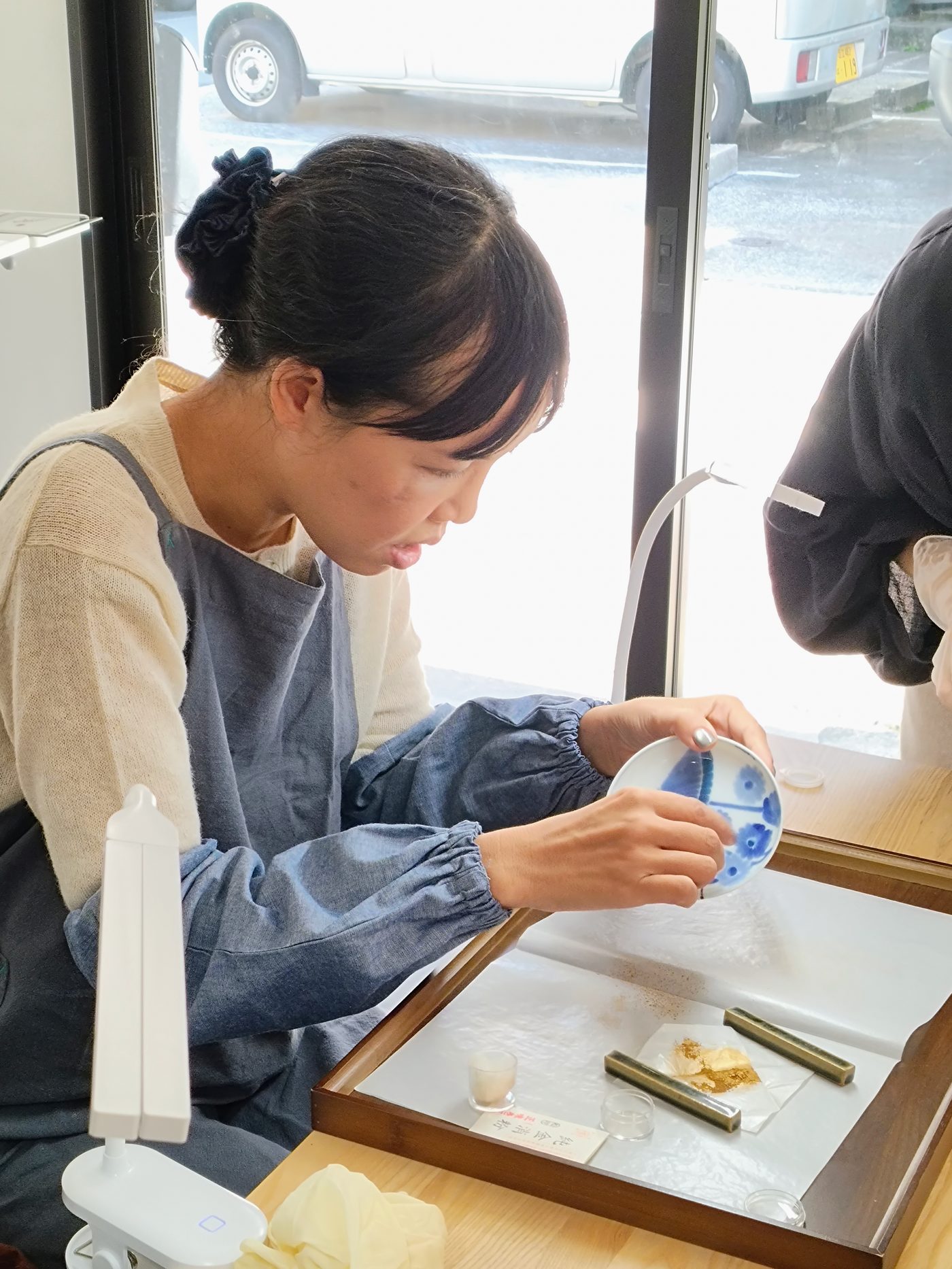 A guest holding her finished dish