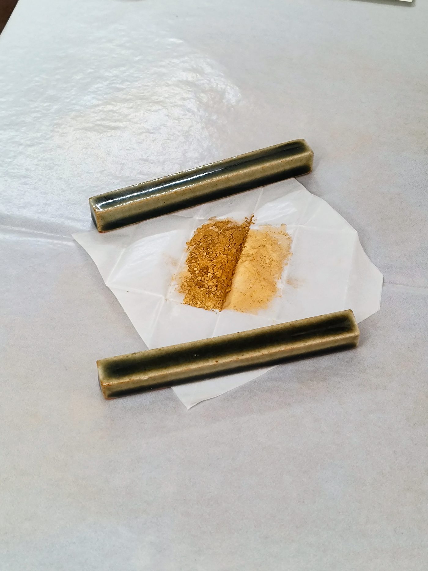 Gold powder on washi paper between two tubes