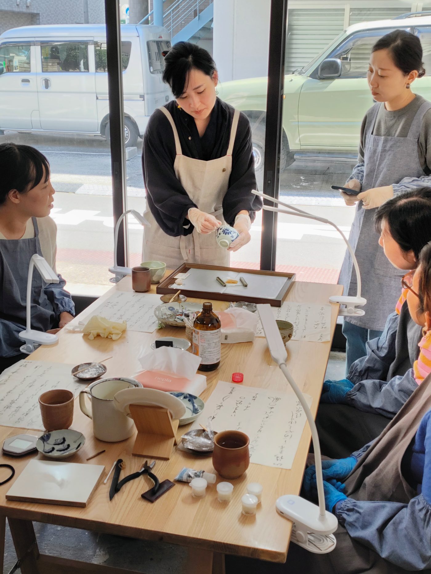 Lynh demonstrating to the group at the workshop table