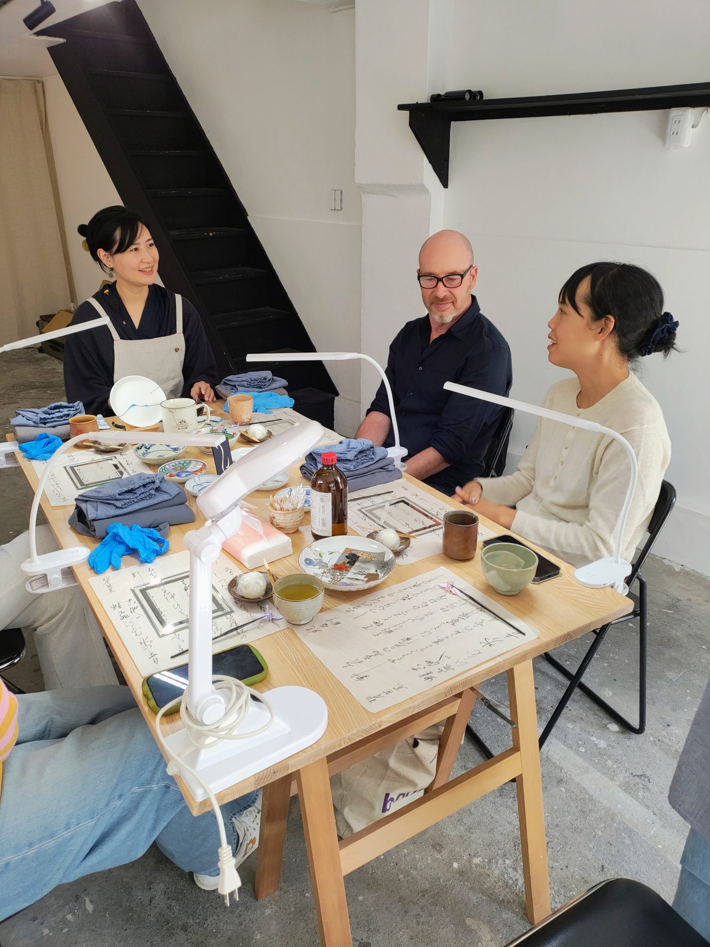 Lynh and guests chatting at the workshop table