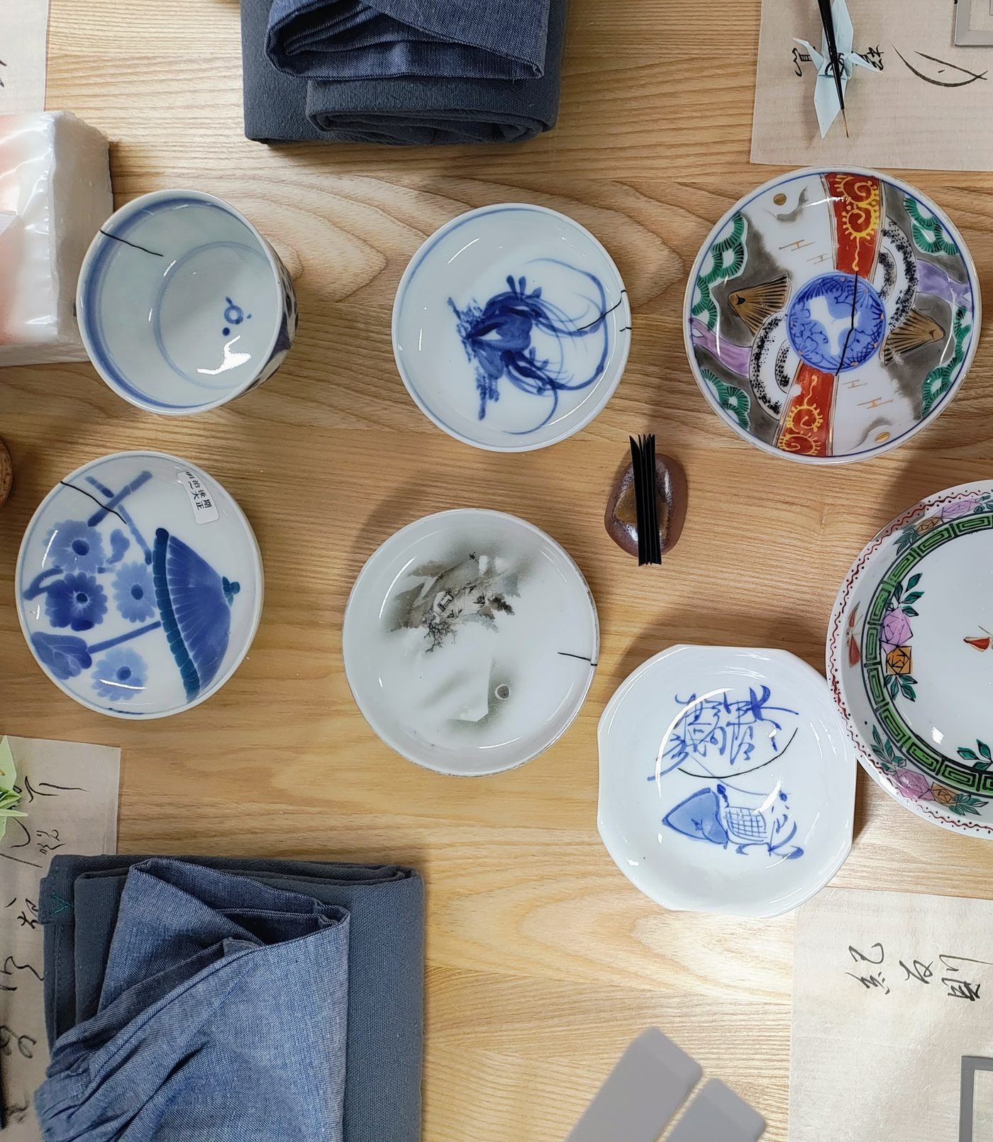 Antique vessels laid out on the workshop table
